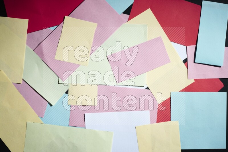 Multicolored paper sheet on black background