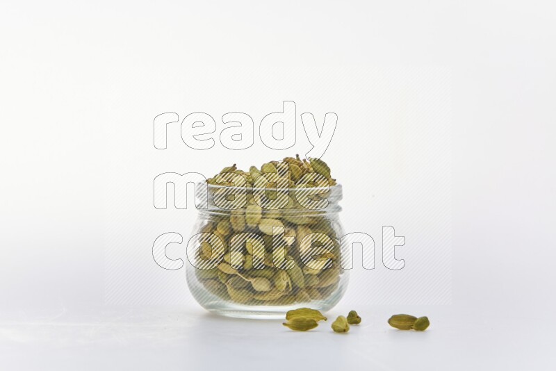 Cardamon in a container on white background
