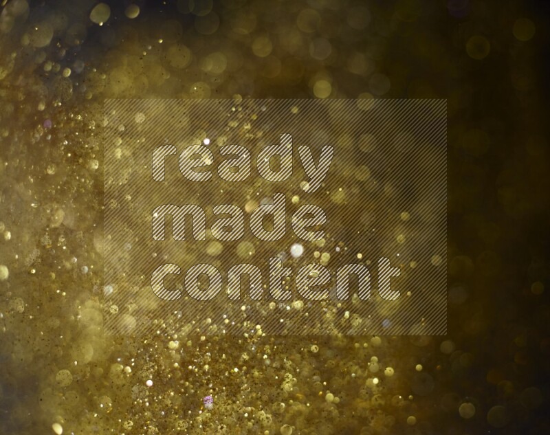 Gold glitter powder isolated on black background