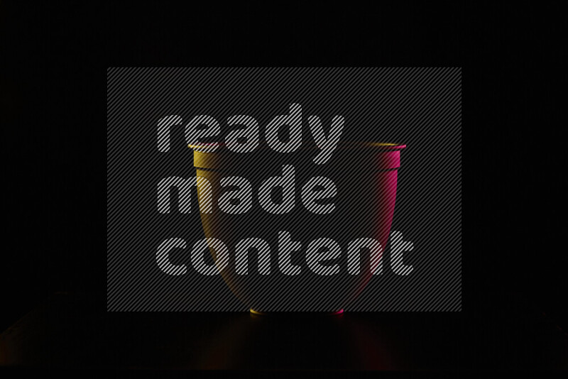 A reflector diffuser lamp shade dish with colored rim light against black background