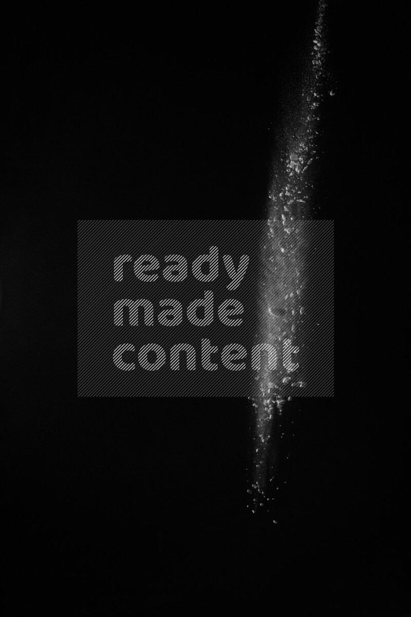 A side view of white powder explosion on black background