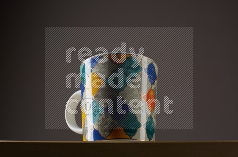 Low angle shot of a decorated cup on grey background