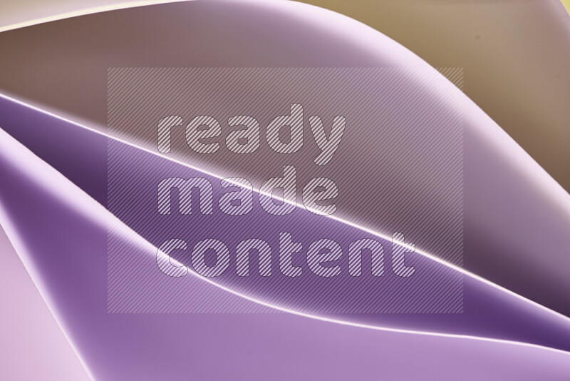 This image showcases an abstract paper art composition with paper curves in purple and gold gradients created by colored light