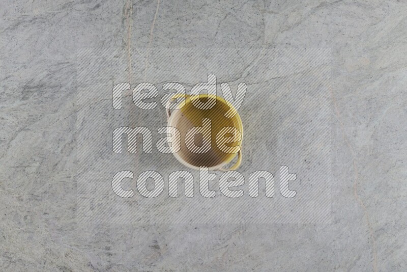 A multicolored pottery Bowl on grey marble background
