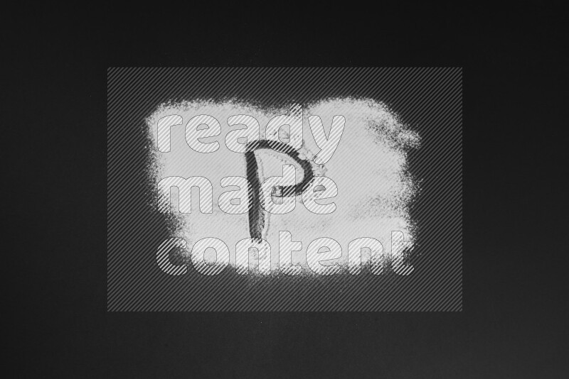 Alphabets written with powder on black background