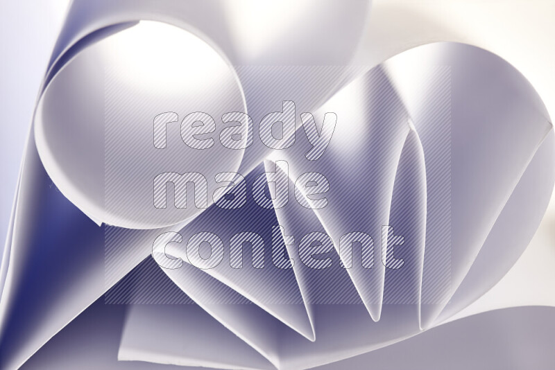 An artistic display of paper folds creating a harmonious blend of geometric shapes, highlighted by soft lighting in grey