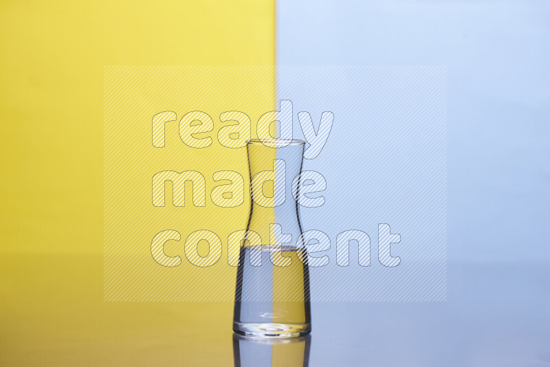 The image features a clear glassware filled with water, set against yellow and light blue background