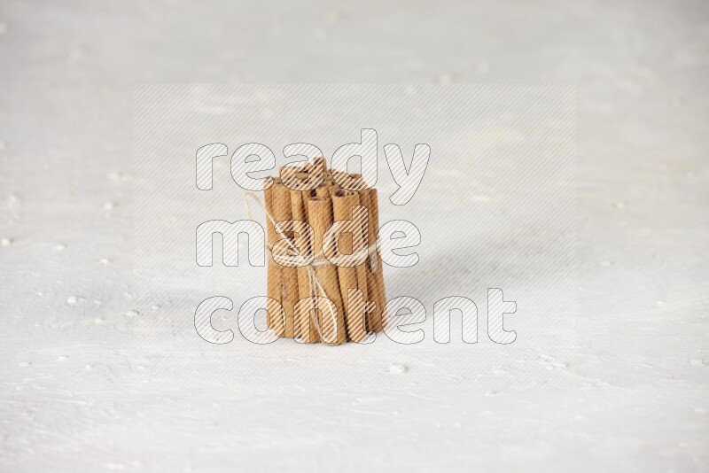 A bounded stack of cinnamon sticks on white background