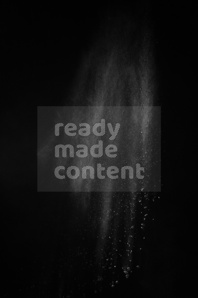 A side view of white powder explosion on black background