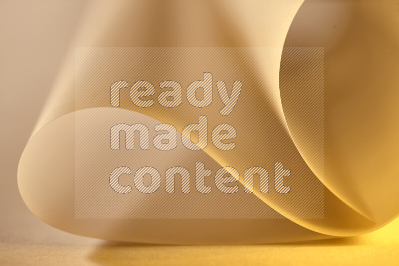 An abstract art piece displaying smooth curves in gold gradients created by colored light