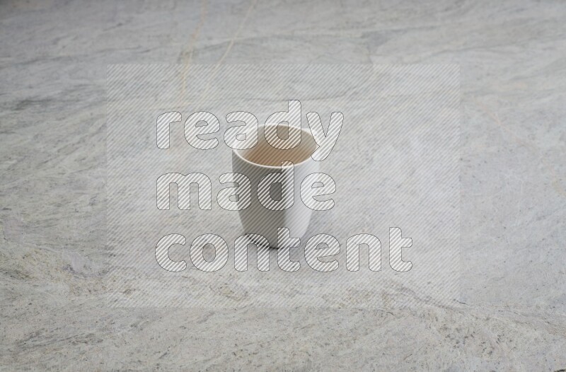 A white ceramic mug on grey marble background