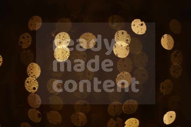 Bokeh light in yellow with water drops