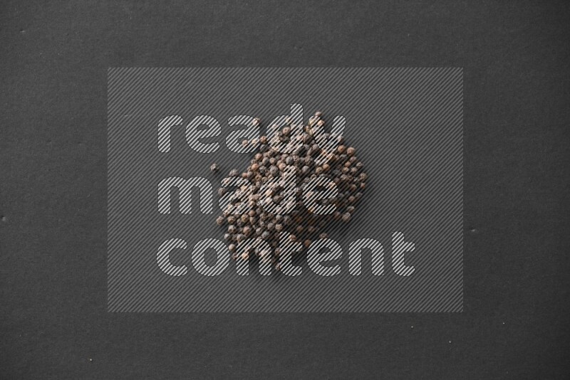Black pepper on a black flooring