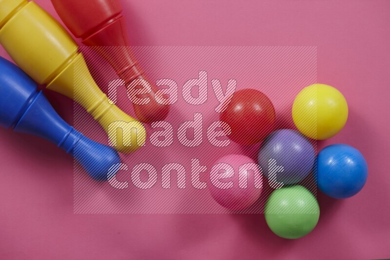Plastic bowling pins with balls on different colored backgrounds (kids toys)