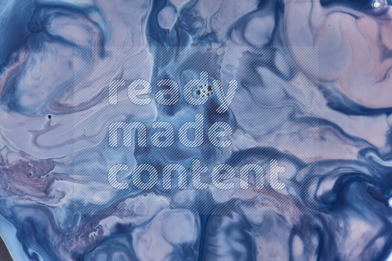 A close-up of abstract swirling patterns in blue, red and white