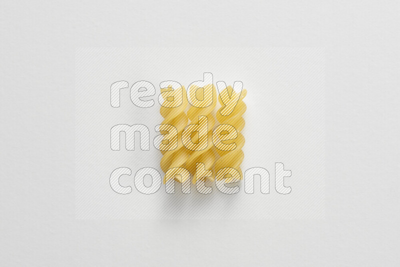 Fusilli pasta on white background