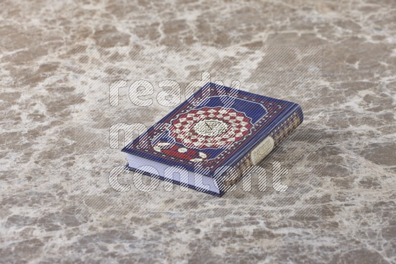 The holy Quran on beige marble background