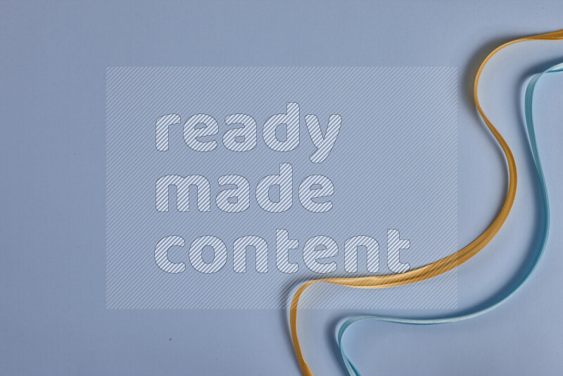 A yellow and blue collection of sewing and tailoring tools arranged on a blue background