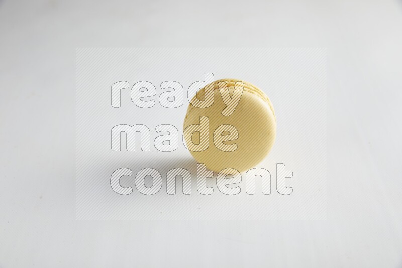 45º Shot of Yellow Vanilla macaron on white background