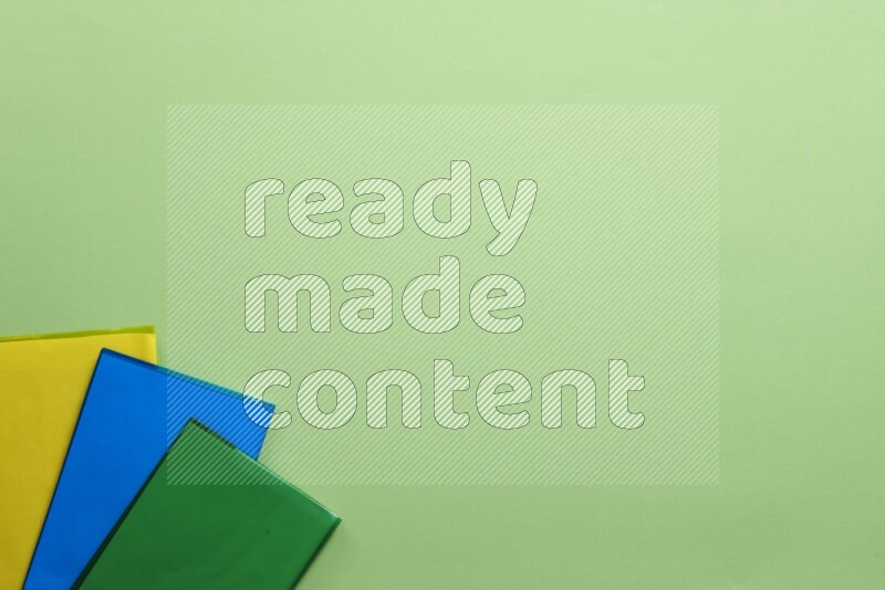 Multicolored notebooks on green background