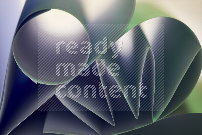 An artistic display of paper folds creating a harmonious blend of geometric shapes, highlighted by soft lighting in green tones