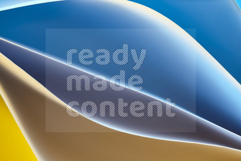 This image showcases an abstract paper art composition with paper curves in blue and yellow gradients created by colored light