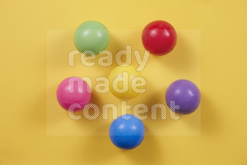 Multicolored plastic balls on different colored backgrounds (kids toys)