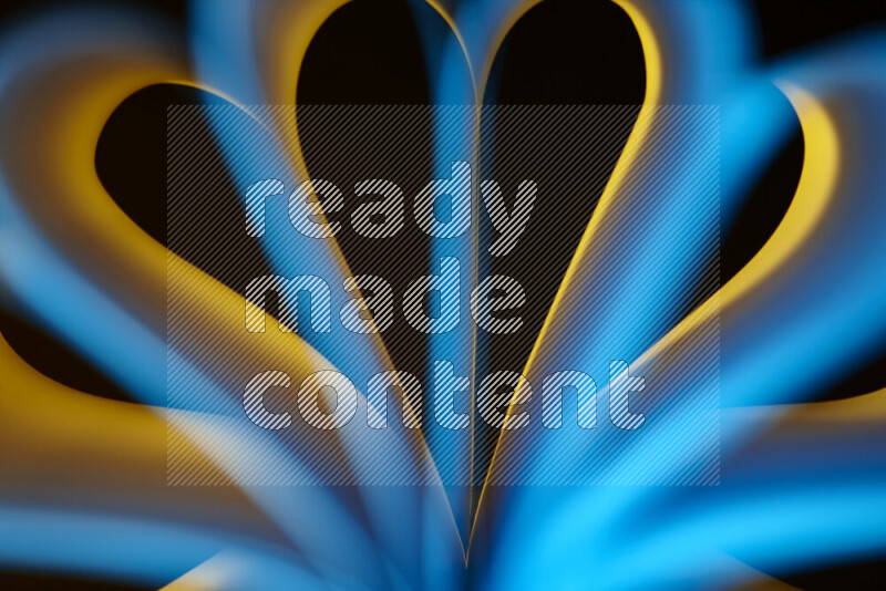 An abstract art piece displaying smooth curves in yellow and blue gradients created by colored light