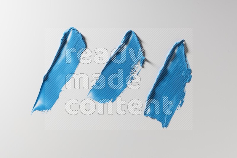 Blue painting knife strokes on a white background
