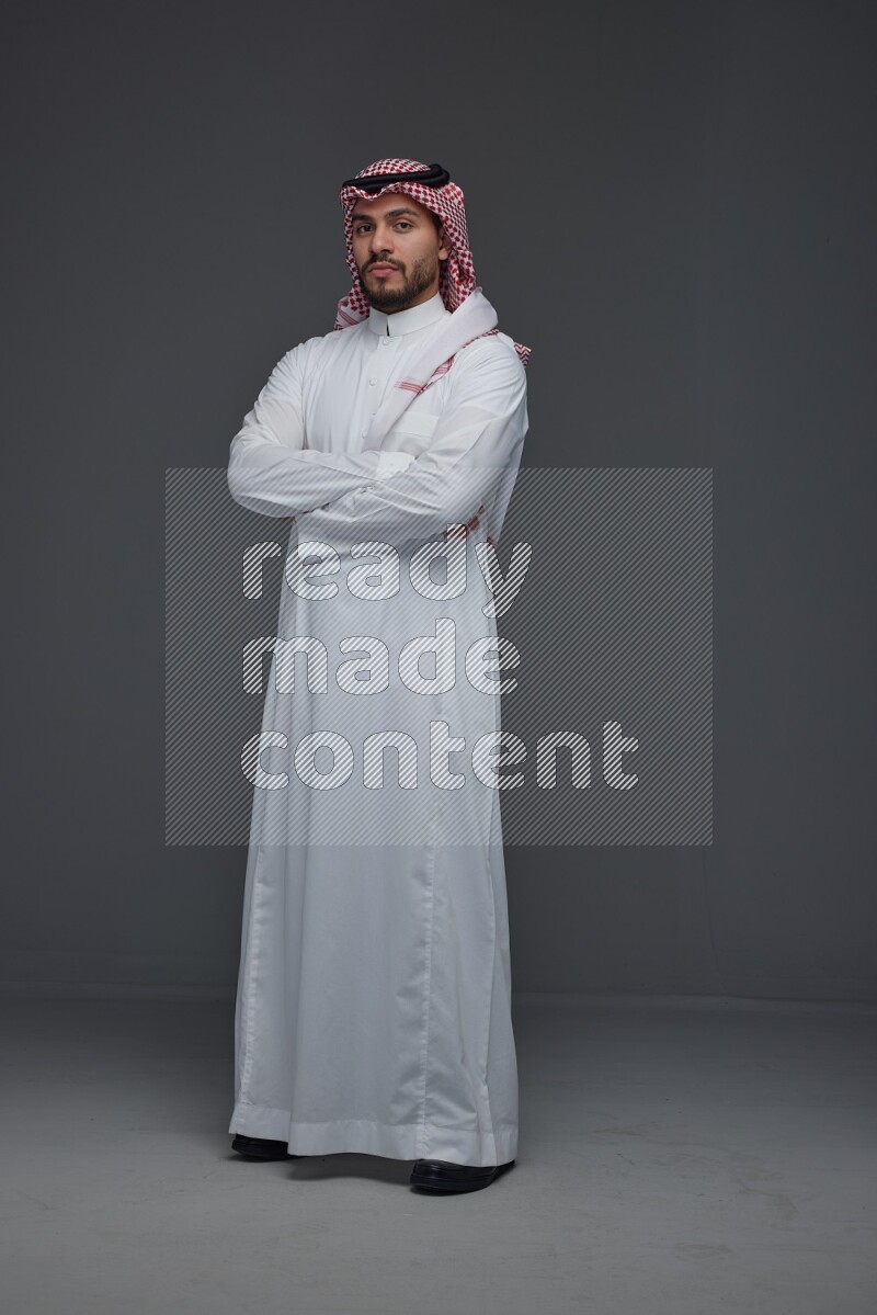 A Saudi man wearing Thobe and Shmagh standing in different poses eye level on a gray background