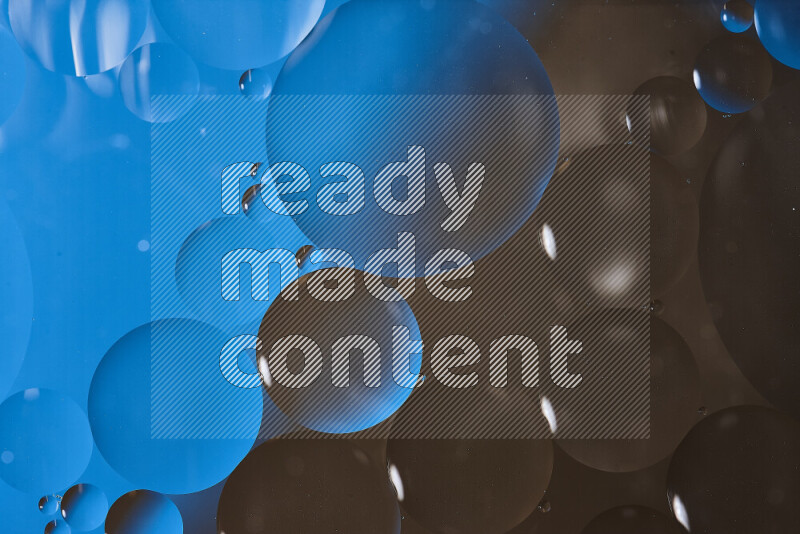 Close-ups of abstract oil bubbles on water surface in shades of blue and brown