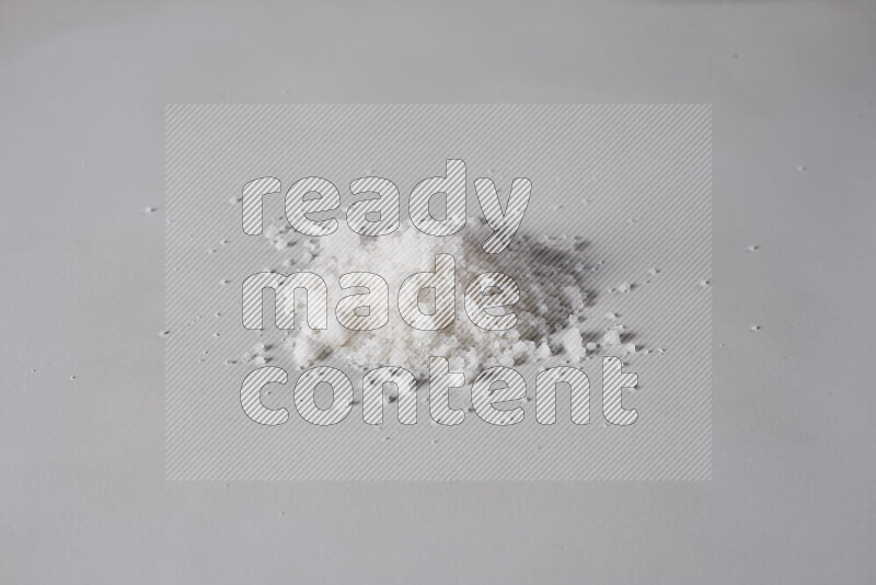 A bunch of coarse sea salt crystals on white background