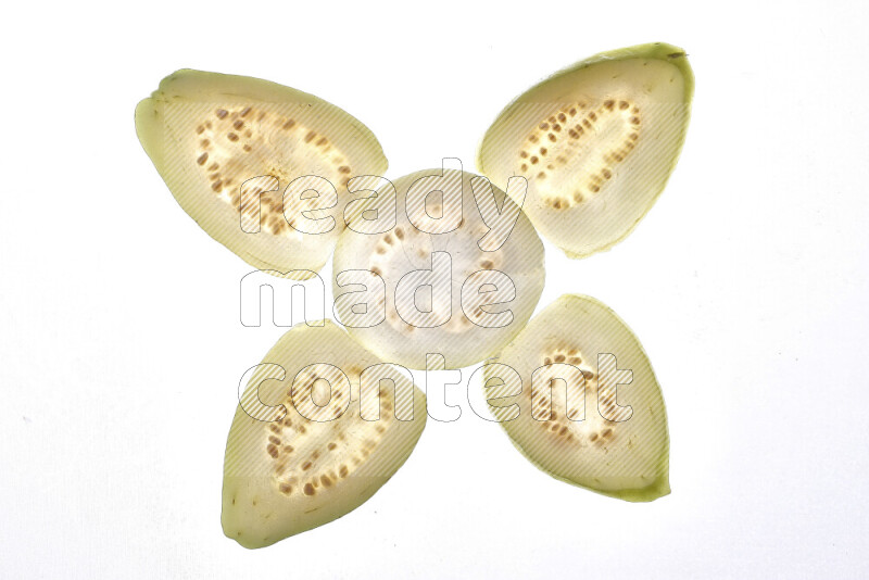 Guava slices on illuminated white background