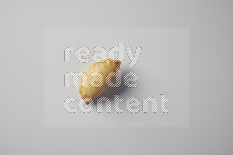 One fried sambosa from a top angle on a white background