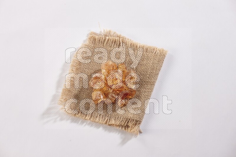 Gum arabic on a burlap piece on white flooring