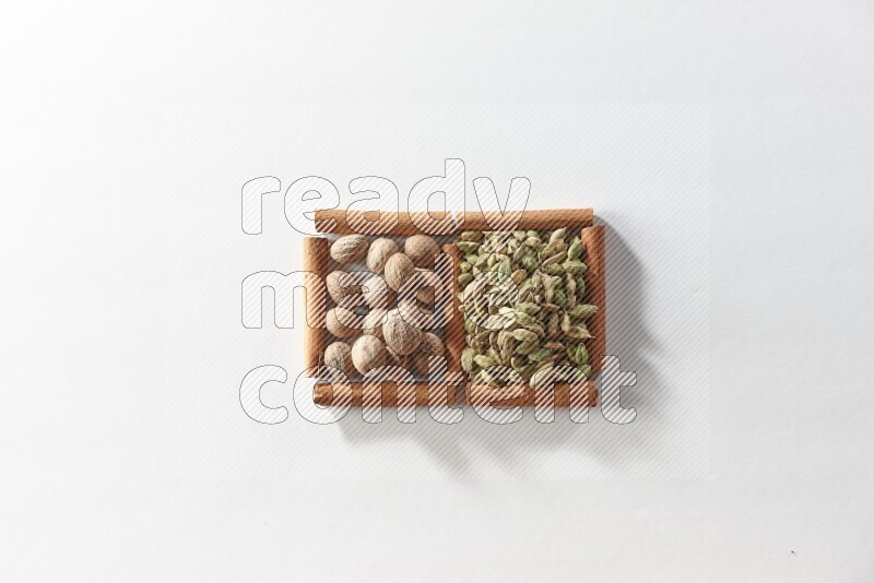 2 squares of cinnamon sticks full of cardamom and nutmegs on white flooring