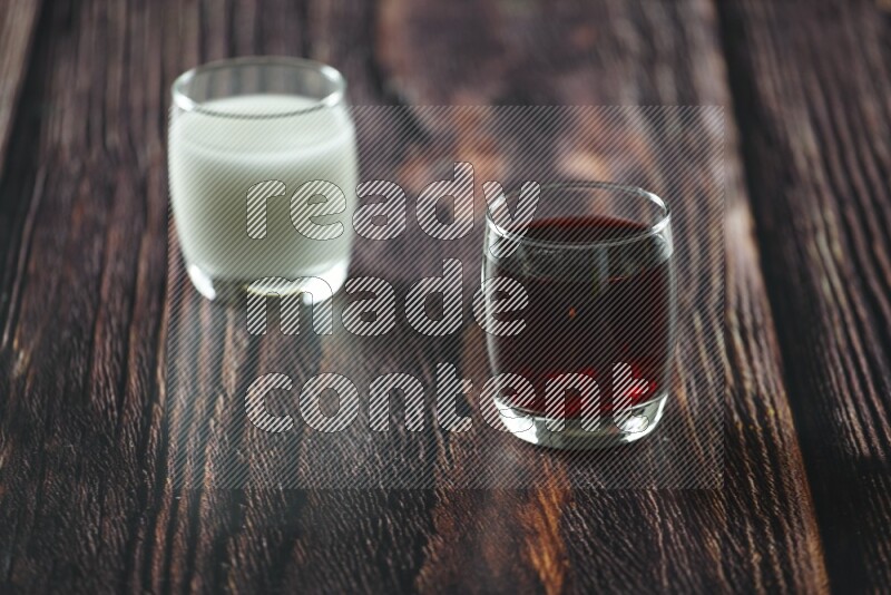 Cold drinks in a glass cup such as water, tamarind, qamar eldin, sobia, milk and hibiscus on wooden background