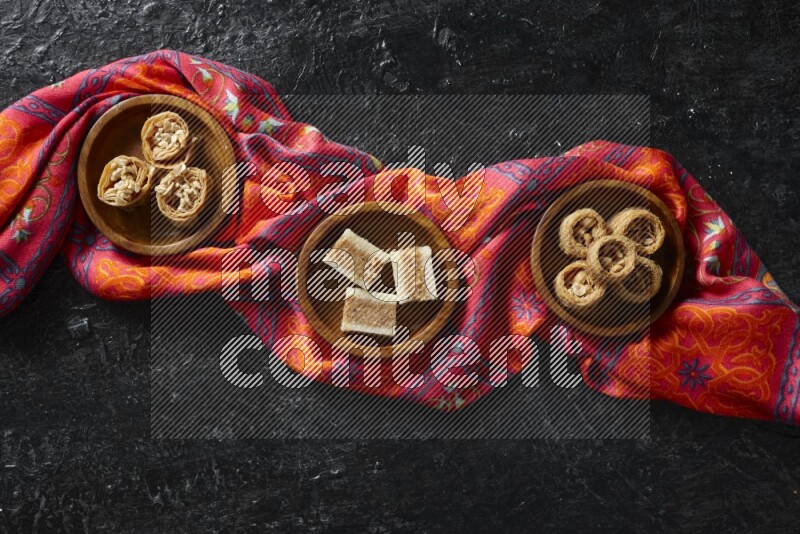 Oriental sweets in wooden bowls in a dark setup