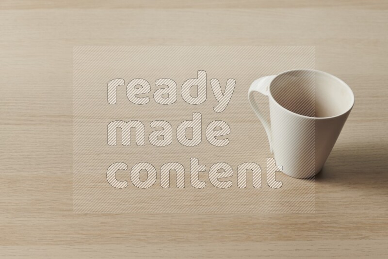 A white ceramic mug on light wooden background