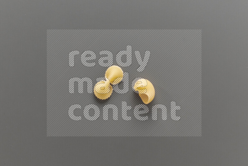 Fiocchi pasta with other types of pasta on grey background