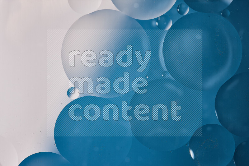 Close-ups of abstract oil bubbles on water surface in shades of white and blue