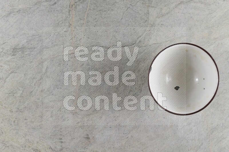 A vintage metal pot on grey marble background