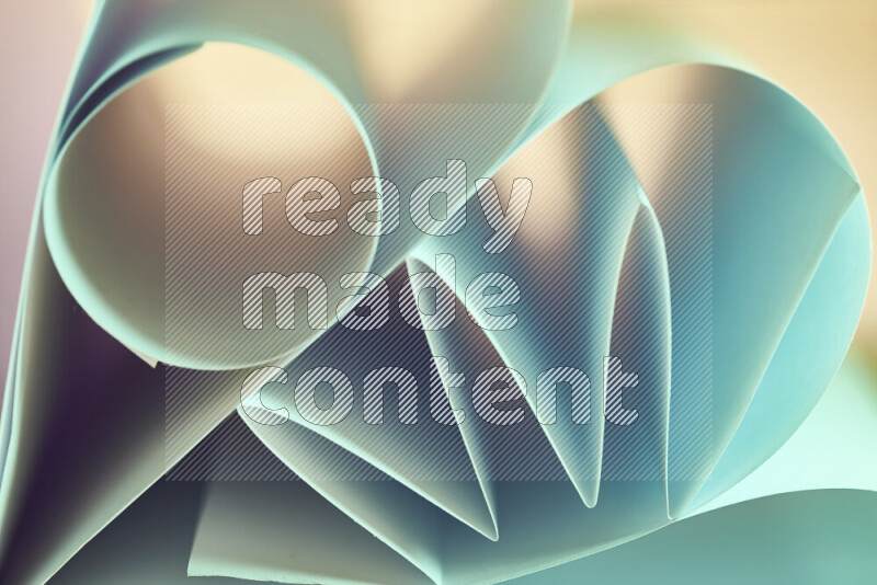 An artistic display of paper folds creating a harmonious blend of geometric shapes, highlighted by soft lighting in green and warm tones