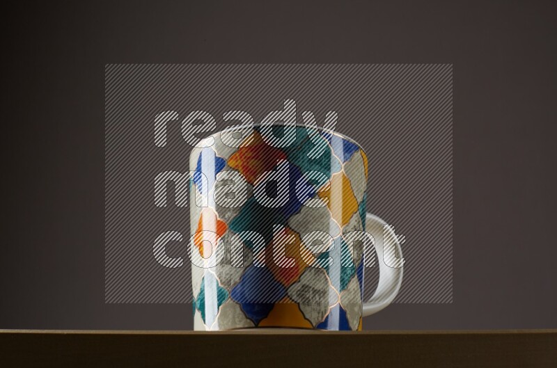 Low angle shot of a decorated cup on grey background