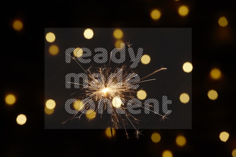 Sparkler candle with yellow light bokeh background