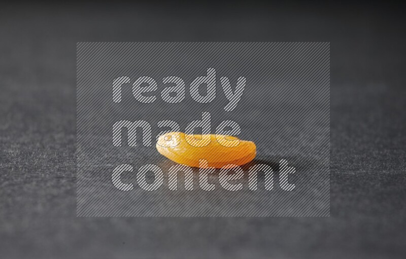 A dried apricot on a black background in different angles