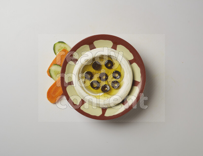 Lebnah garnished with sliced olives in a traditional plate on a white background