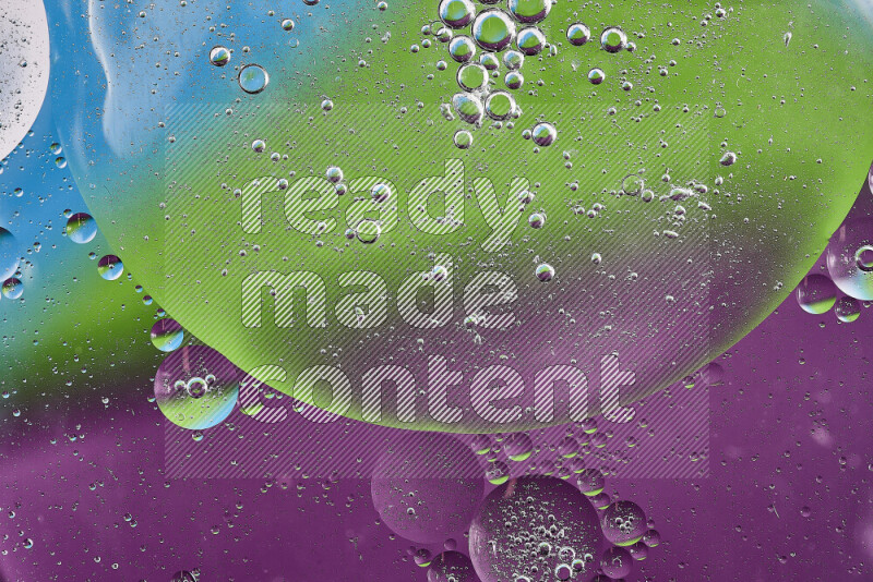 Close-ups of abstract oil bubbles on water surface in shades of purple, green and blue