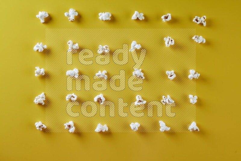 Popcorn flakes on a yellow background in different angles