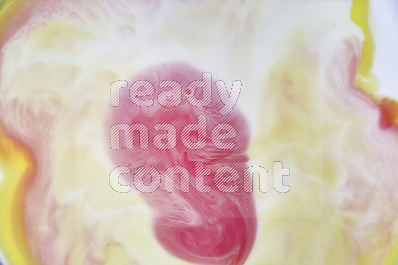 A close-up of abstract swirling patterns in yellow, red and white